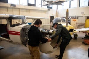 Two students work on an aircraft in the Aviation Lab at NCC